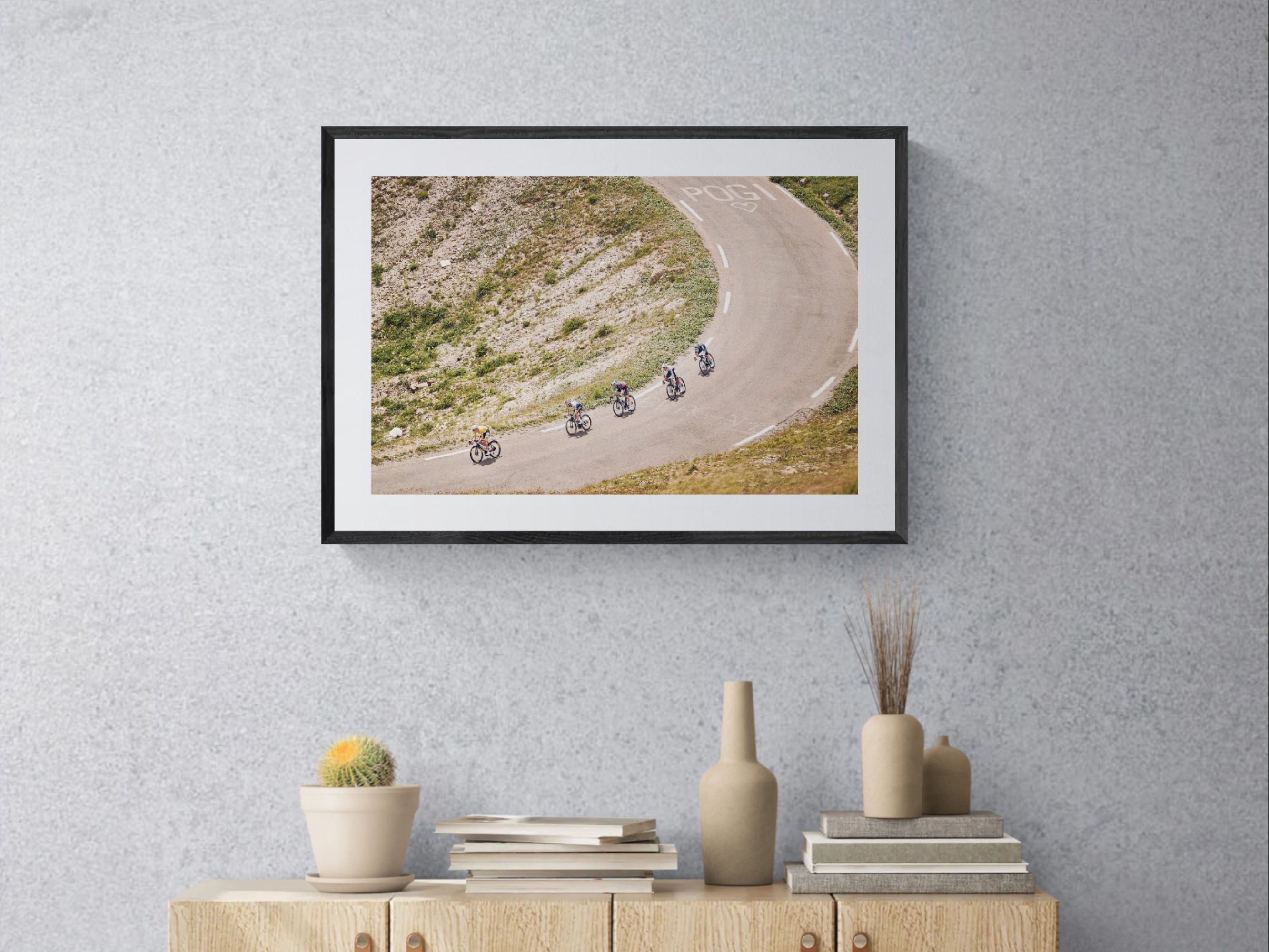 Tour de France Col du Galibier print framed on wall near window with lamp