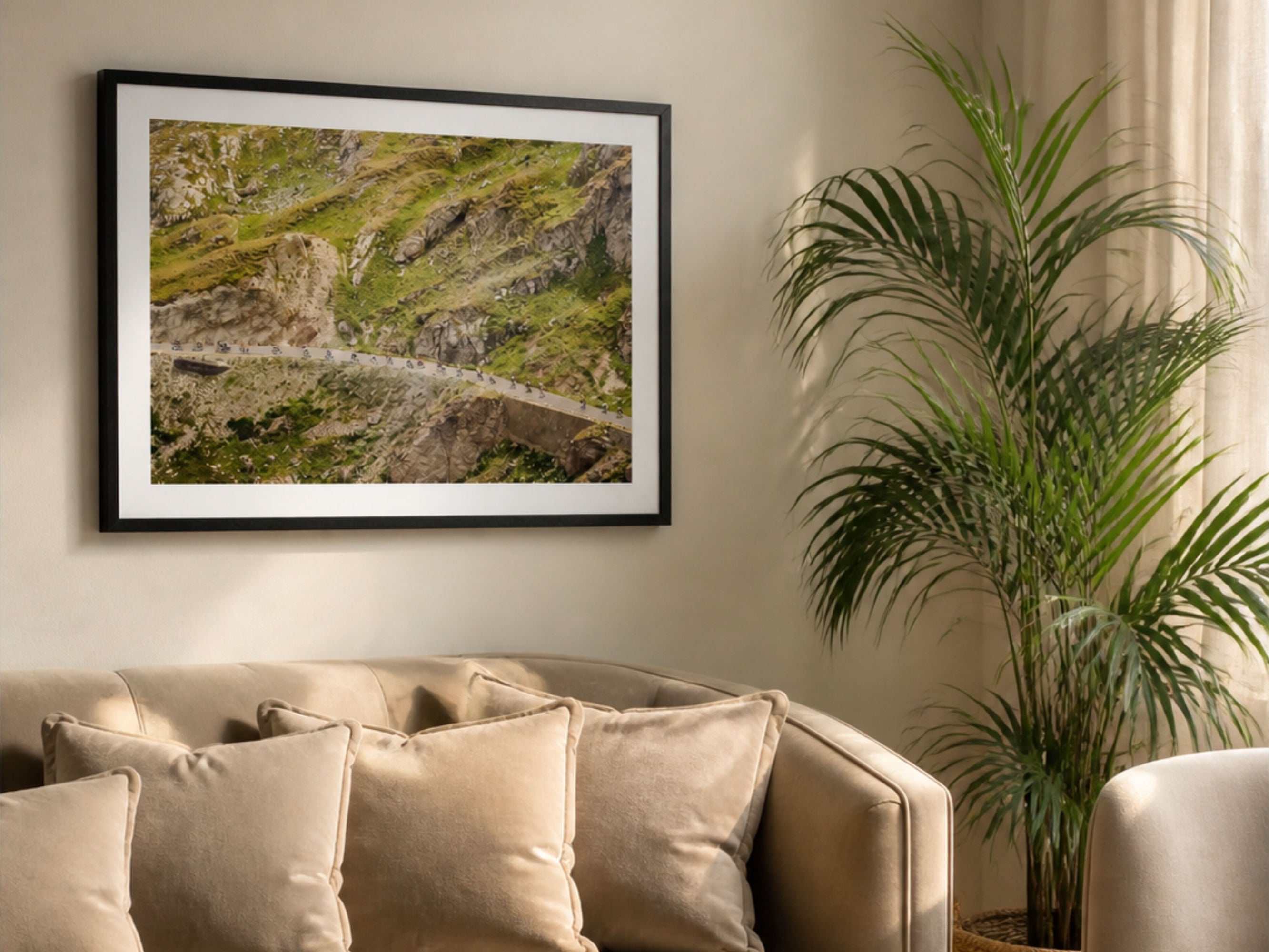 Cycling photography print of Col du Galibier descent styled above sofa with plant