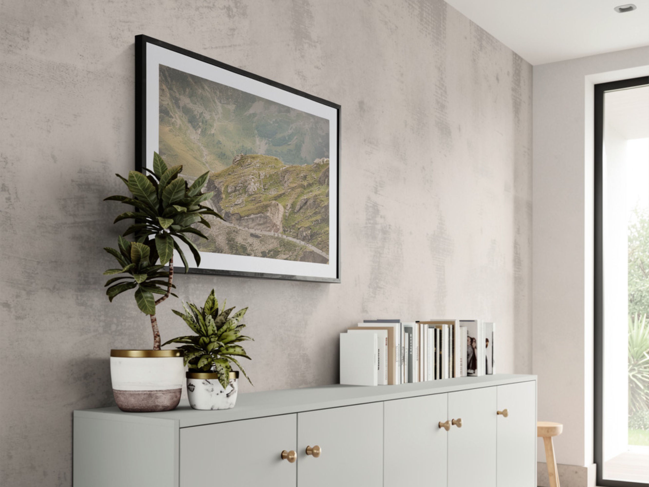 Cycling photography print of Col du Galibier descent styled above sofa with plant